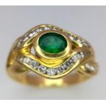 An 18K Yellow Gold Emerald and Diamond Ring. Central oval emerald eye with beautiful diamond lids!