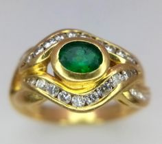 An 18K Yellow Gold Emerald and Diamond Ring. Central oval emerald eye with beautiful diamond lids!