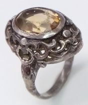 A vintage silver lemon oval Citrine solitaire ring with further decoration surround. Total weight