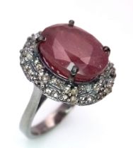 A Ruby and Diamond Gemstone Ring set in 925 Silver. Central 8ct ruby with a double row 0.80ctw