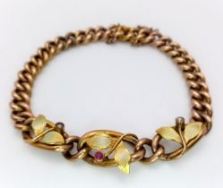 AN ANTIQUE 9K GOLD BRACELET WITH ORNATE LEAF EFFECT , SEED PEARLS AND PINK RUBY . 11.2gns 17cms