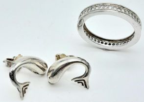 A STERLING SILVER DOLPHIN STUD EARRINGS AND FULL STONE SET ETERNITY RING. SIZE K. 6G