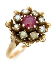 A 9K YELLOW GOLD STONE SET CLUSTER RING. 4.5G. SIZE K (BELIEVED TO BE RUBY AND PEARL).
