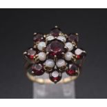 A 9K GOLD GARNET AND OPAL CLUSTER RING . 5.25gms size Q