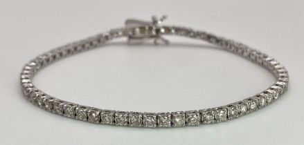 An 18K White Gold Diamond Tennis Bracelet. 62 brilliant round cut diamonds - 4.3ctw. 18cm. 8.2g
