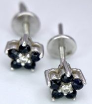 A Pair of 14K White Gold, Sapphire and Diamond Stud Earrings. 1.41g total weight.