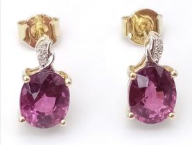A Pair of 10K Yellow Gold Diamond and Ruby Stud Earrings. 2g total weight.