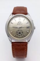A Vintage Orient Day Pointer Automatic Gents Watch. Brown leather strap. Stainless steel case -
