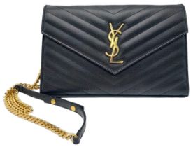 A Saint Laurent Black Leather Flap Handbag. Decorative chevron exterior with gold furniture. YSL