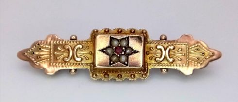 A vintage 9 K yellow gold brooch with a garnet and seed pearls. length: 40 mm, weight: 2.1 g.