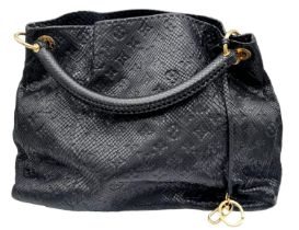 A Louis Vuitton Monogram Black Snakeskin Tote Bag. Gold tone hardware. Spacious black leather