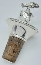 AN UNUSUAL BOTTLE STOP, A CORK WITH SOLID SILVER TOP WITH FLYING FISH . 39.6gms