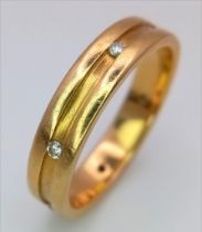 AN 18K GOLD BAND RING WITH 6 INSETDIAMONDS .5.8 gms size R