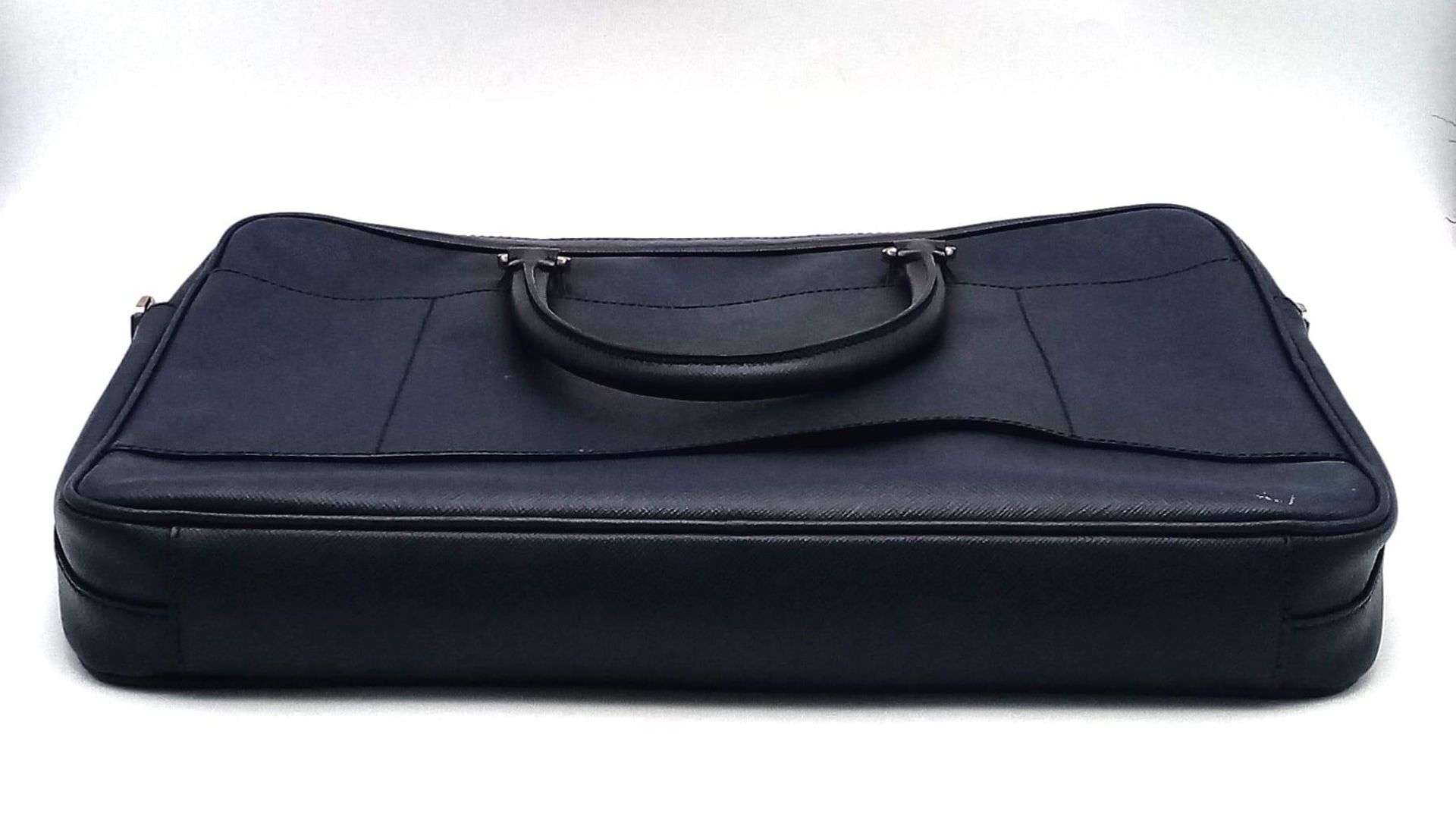 A Prada Saffiano Briefcase. Navy blue textured leather exterior. Prada logo badge. Name tag. Quality - Image 3 of 6