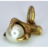 A 9K Yellow Gold, Eagle Claw and Pearl Pendant/charm. 0.91g total weight.