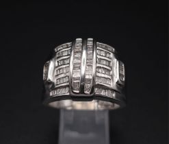 A 10K White Gold Baguette Diamond Cluster Ring. Size V. 1ctw. 7.4g total weight.