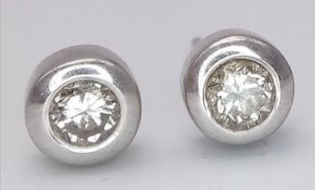 A Pair of 14K White Gold Tinted Diamond Stud Earrings. No backs. 1.85g total weight. Ref: 15817