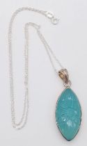 An Unworn and Unique, Sterling Silver Carved Blue Gem Set Pendant Necklace. 50cm Length Chain.
