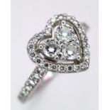 A PLATINUM DIAMOND CLUSTER RING IN THE SHAPE OF A HEART - 0.63CT. 5.3G. SIZE P