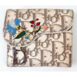 A Christian Dior Wallet. Exterior Dior branding with colourful floral decoration. Two interior