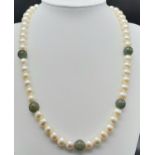 A Cultured White Pearl and Jade Necklace with a 9K Yellow Gold Clasp. 46cm length.