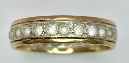 A 9 K yellow gold, stone set, eternity ring. One stone missing. Size: O, weight: 2.7 g.
