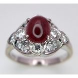 A 9K WHITE GOLD DIAMOND & CABOCHON RUBY RING - 0.40CT. 4.4G. SIZE M