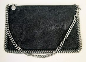 A Stella McCartney Falabella Black Suede Handbag. Silver tone hardware. Burgundy textile interior.