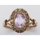 AN ANTIQUE AMETHYST AND SEED PEARL RING IN 9K GOLD. 2.1gms size R