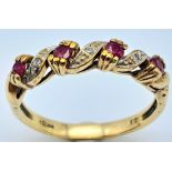 A 9K YELLOW GOLD DIAMOND & RUBY RING, IN THE SWIRL DESIGN 2.1G SIZE M A/S 2010