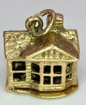 A 9K yellow gold opening house charm. 2.7g