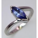 An 18K White Gold Tanzanite Crossover Ring. Size J. 2.55g total weight.