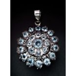 A Blue Topaz Decorative Floral Pendant set in 925 Sterling silver. 8ctw. W-7.5g. 4cm. Comes with a