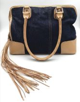A Dolce and Gabbana Denim and Leather Handbag. Tasselled exterior zip. Leopard print textile