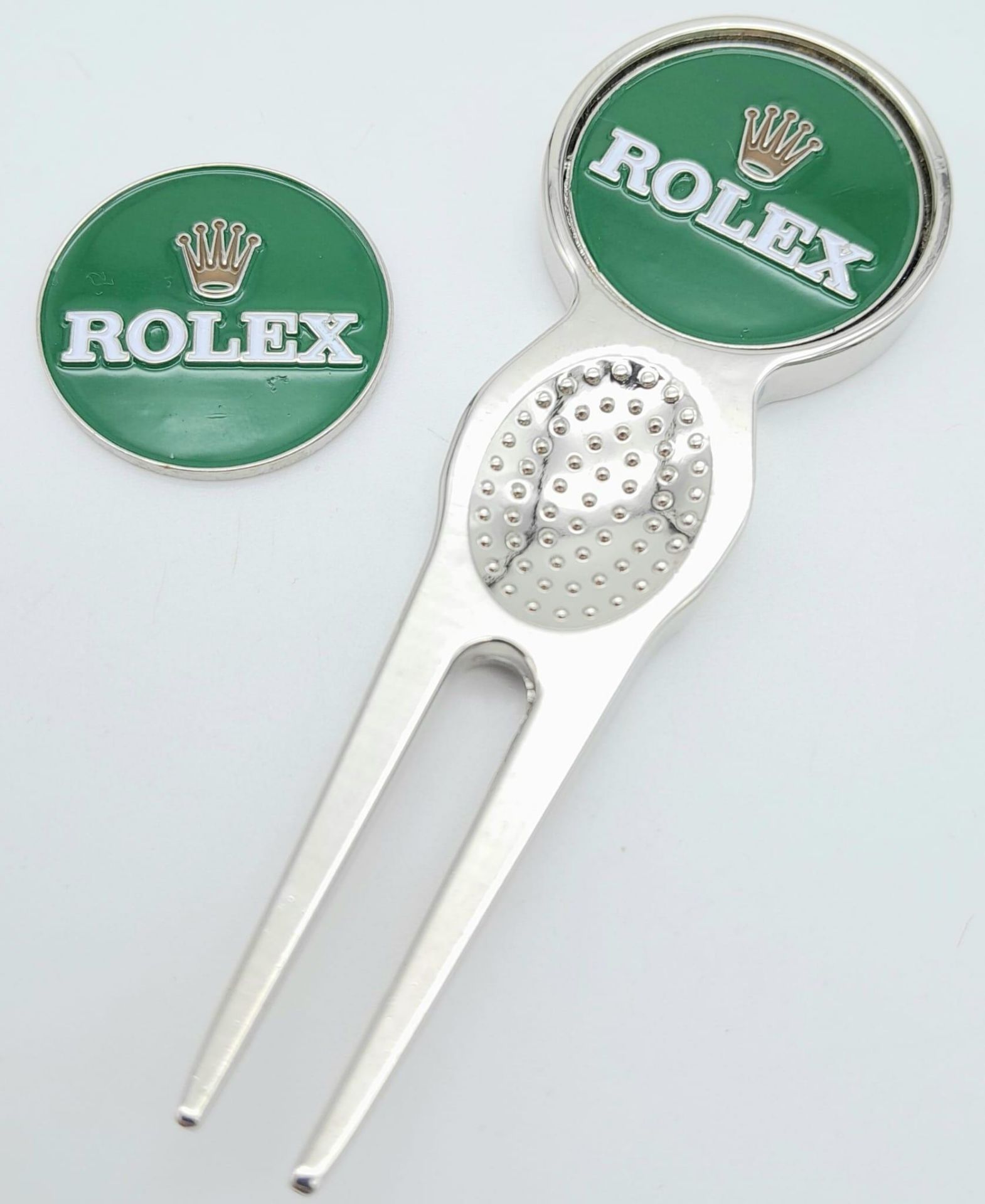 A Rolex Branded Putting Green Divot Repair Tool with Removable Ball Marker plus spare marker. As