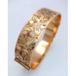 A vintage 50 MICRON 9CT rolled gold click-on bangle with flower motif. Total weight 29.2G.