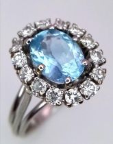 An 18K WHITE GOLD DIAMOND & BLUE STONE (BELIEVED TO BE AQUAMARINE CLUSTER RING 0.60CT DIMAONDS 5.