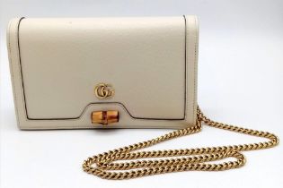 A Gucci Diana Mini Bag. Cream leather exterior with bamboo and gold tone monogram and chain shoulder