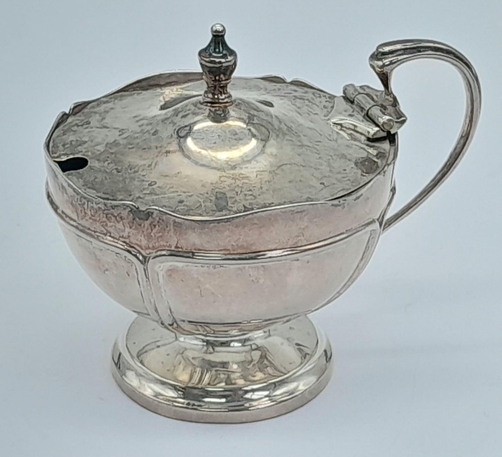 A SILVER FOOTED SALT HALLMARKED BIRMINGHAM 1913 WITH BLUE GLASS LINER BUT MISSING THE SPOON . SILVER
