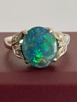 18 carat WHITE GOLD and FIRE OPAL RING. Having a 2 carat Green Fire Opal mounted to top with