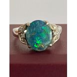 18 carat WHITE GOLD and FIRE OPAL RING. Having a 2 carat Green Fire Opal mounted to top with