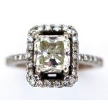 A 14K White Gold Princess Cut Diamond Ring. A beautiful (slightly tinted) 1.13ct central princess