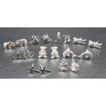 9 PAIRS OF STERLING SILVER STUD EARRINGS IN THE SHAPE OF CAT, CROSS, TEDDY, LEAF, ELEPHANT, MUSIC