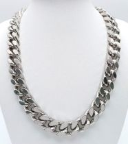 A LOUIS VUITTON HEAVY SILVER CURB LINK NECK CHAIN . WITH ALL LINKS HAVING THE "LV"MARKINGS .