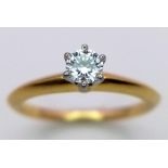 A Tiffany and Co. 18K Yellow Gold Diamond Solitaire Ring. This VVS2 0.19ct brilliant round cut