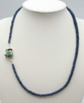 A 90ct Blue Sapphire Small Rondelle Bead Necklace with an Emerald Clasp - set in 925 Silver. 42cm
