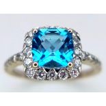 A 9K WHITE GOLD DIAMOND & LONDON BLUE TOPAZ RING. TOTAL WEIGHT 2.1G. SIZE I