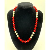 A Red Coral and White Akoya Pearl Necklace. 7/8mm beads. 44cm necklace length. Gilded spacers and