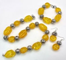 A substantial necklace, bracelet and earrings set with Tibetan silver alternating with amber