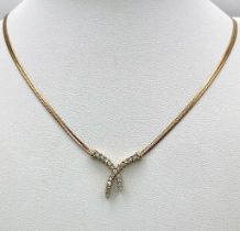 A 9K Yellow Gold Herringbone Necklace with an Attached Eternal Crossover Diamond Pendant. 40cm